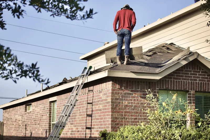 Professional roofer working on a residential roof in Gardere